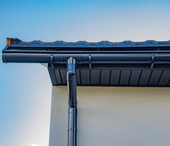 Gutter with downpipe on the roof of a house. Gutter with downpipe on the roof a house.